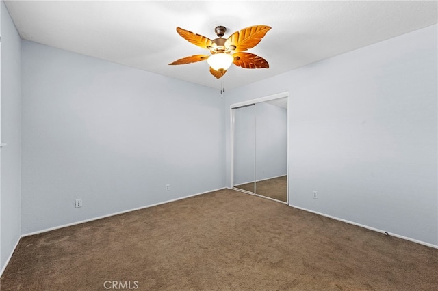 unfurnished bedroom featuring a closet, a ceiling fan, and carpet floors