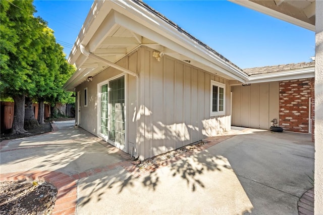 view of home's exterior featuring a patio and fence