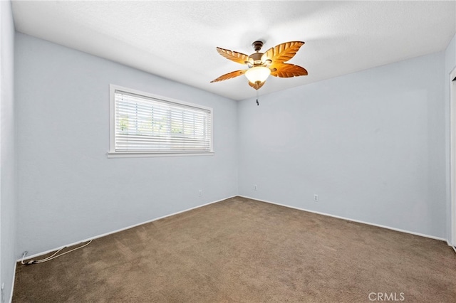 spare room with carpet floors, a textured ceiling, and ceiling fan