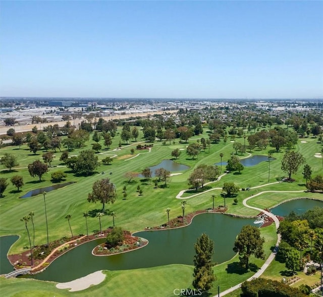 drone / aerial view with a water view and view of golf course