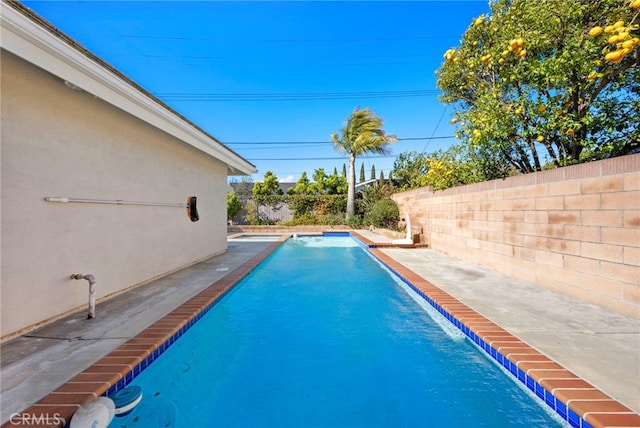 view of swimming pool with a patio, a fenced backyard, and a fenced in pool