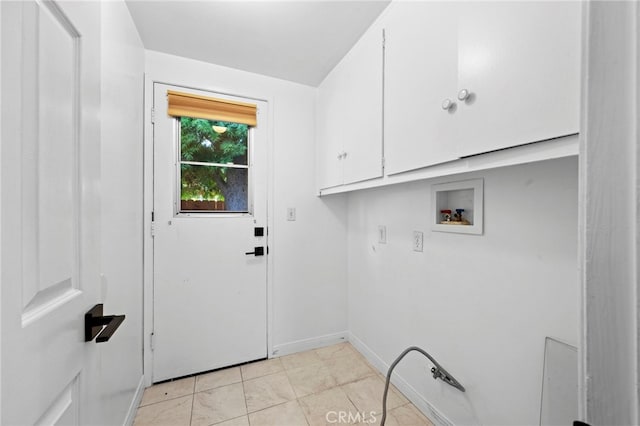 washroom with washer hookup, cabinet space, and baseboards