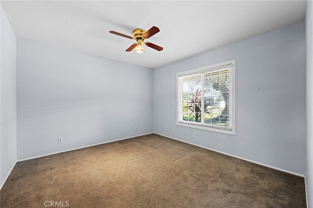 carpeted empty room with a ceiling fan