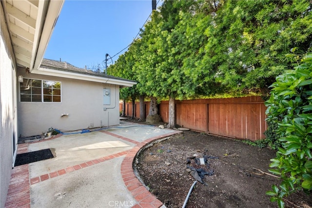 view of yard with a patio and fence