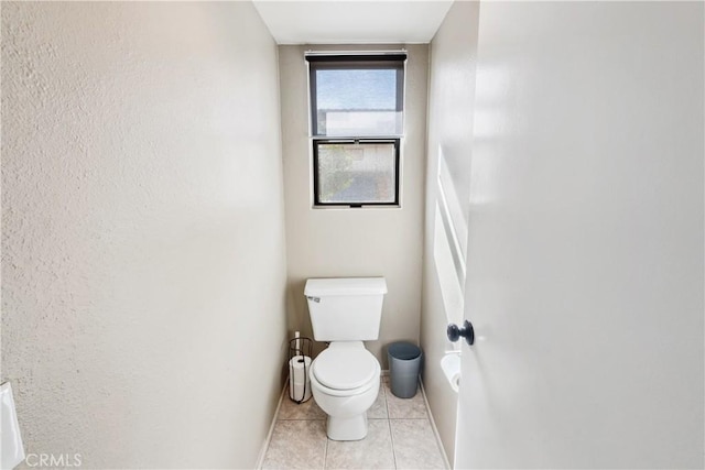 bathroom featuring tile patterned floors and toilet