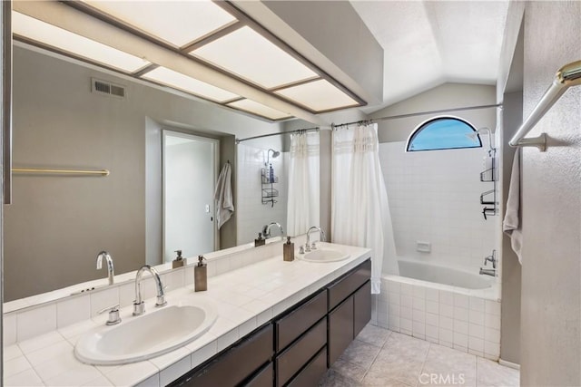 full bathroom featuring a sink, visible vents, tile patterned flooring, and vaulted ceiling