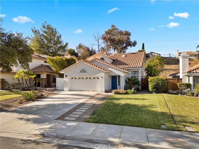 mediterranean / spanish-style house featuring fence, concrete driveway, a tile roof, stucco siding, and an attached garage