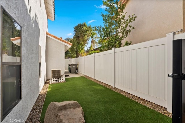 view of yard featuring cooling unit and a fenced backyard