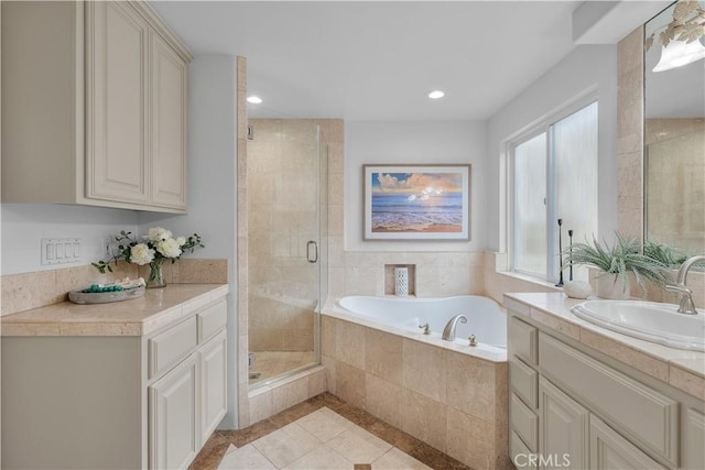 bathroom featuring tile patterned floors, recessed lighting, a stall shower, a bath, and vanity