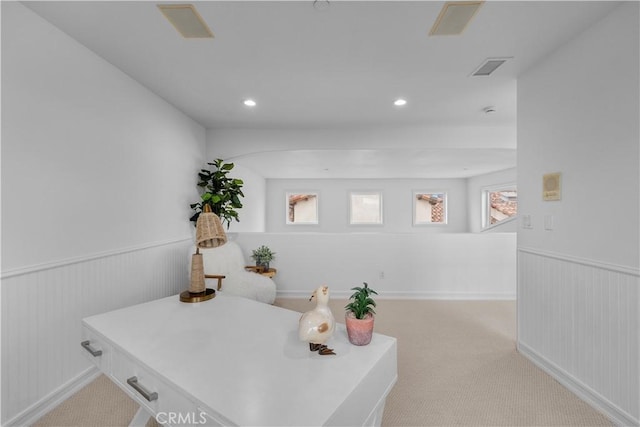 carpeted home office featuring recessed lighting, visible vents, and wainscoting