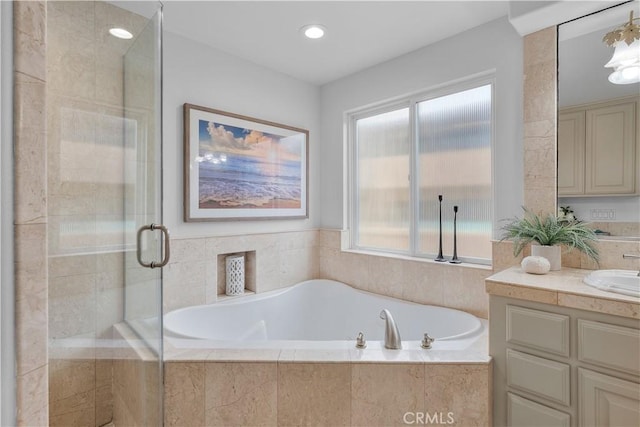 bathroom with a bath, recessed lighting, a stall shower, and vanity