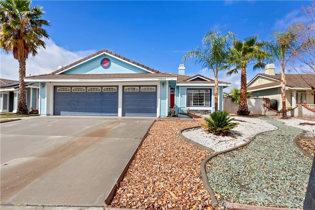 ranch-style house with a garage, concrete driveway, and fence