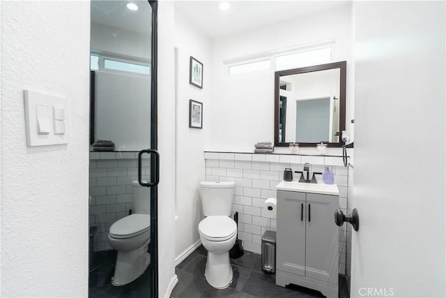 11894 Truro Ave, Hawthorne, CA 90250 - full bathroom featuring vanity, tile walls, toilet, and a stall shower