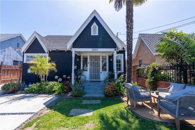 11894 Truro Ave, Hawthorne, CA 90250 - view of front of house featuring a front yard, fence, and an outdoor hangout area