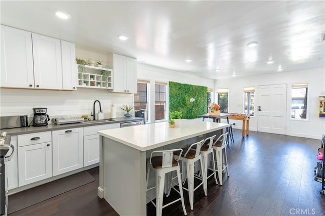 11894 Truro Ave, Hawthorne, CA 90250 - kitchen featuring a sink, open shelves, a center island, a kitchen breakfast bar, and dark wood-style flooring