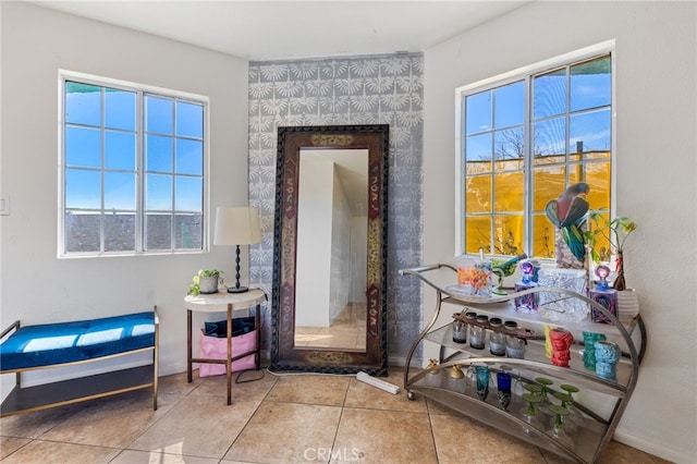 sitting room with tile patterned flooring and baseboards