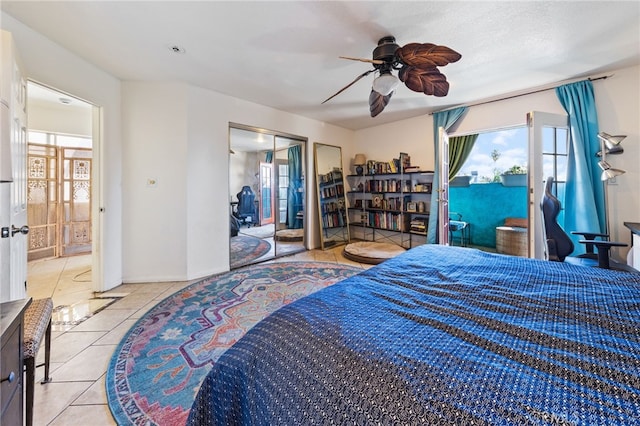 tiled bedroom featuring access to outside and a ceiling fan