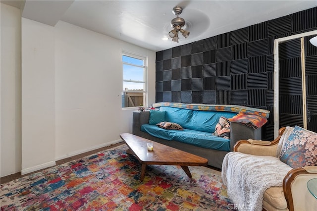 living area with an accent wall and baseboards