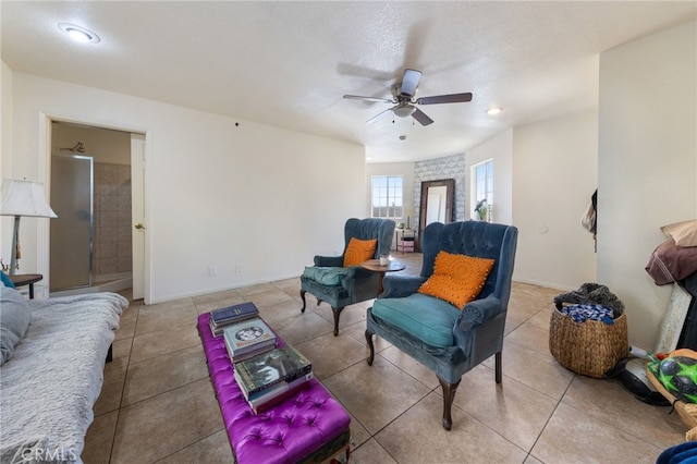 tiled living room with a ceiling fan