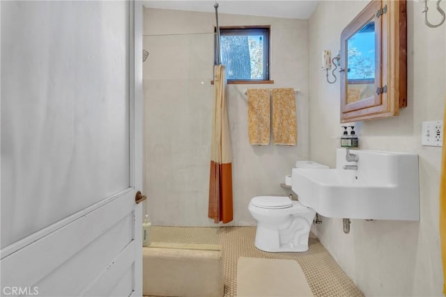 full bathroom with tile patterned floors, toilet, a stall shower, and a sink