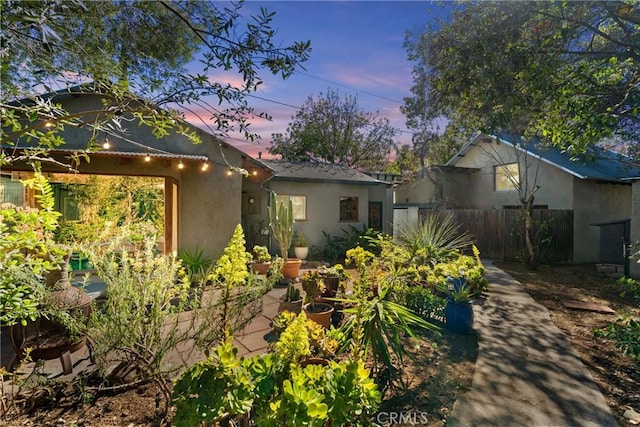 exterior space with fence and stucco siding