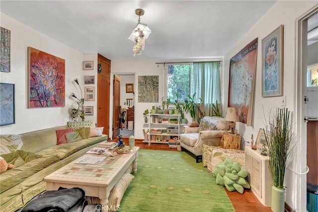 living room with an inviting chandelier and wood finished floors