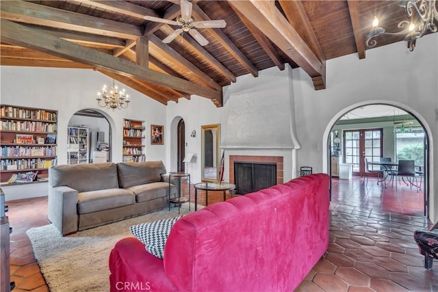 tiled living area with high vaulted ceiling, beam ceiling, a fireplace, arched walkways, and wooden ceiling