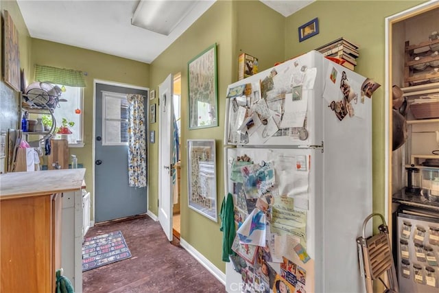 kitchen with freestanding refrigerator and baseboards