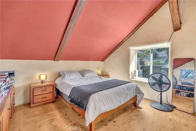 bedroom with wood finished floors and vaulted ceiling