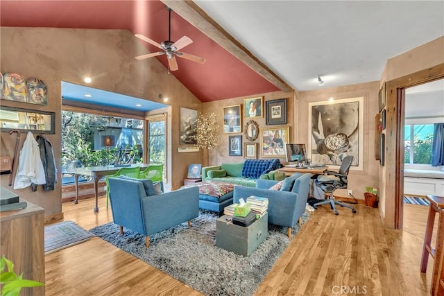 living room featuring ceiling fan, high vaulted ceiling, and wood finished floors