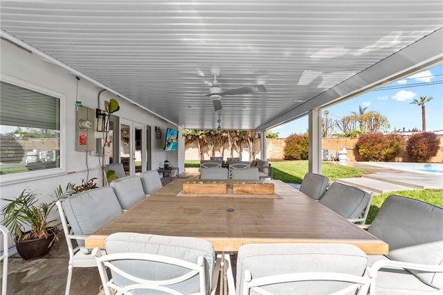 view of patio / terrace with a fenced backyard, outdoor dining space, and a ceiling fan