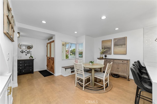 dining area with recessed lighting, light wood-type flooring, and baseboards