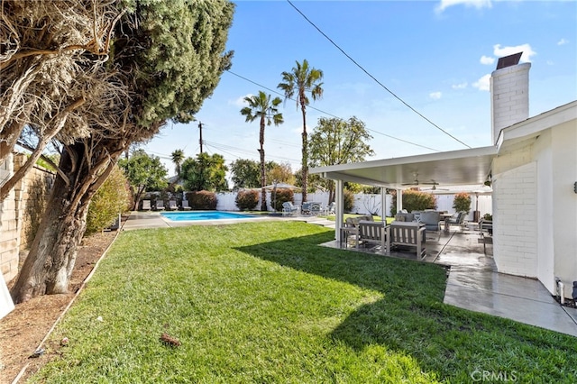 view of yard with a patio area, a fenced in pool, a fenced backyard, and ceiling fan