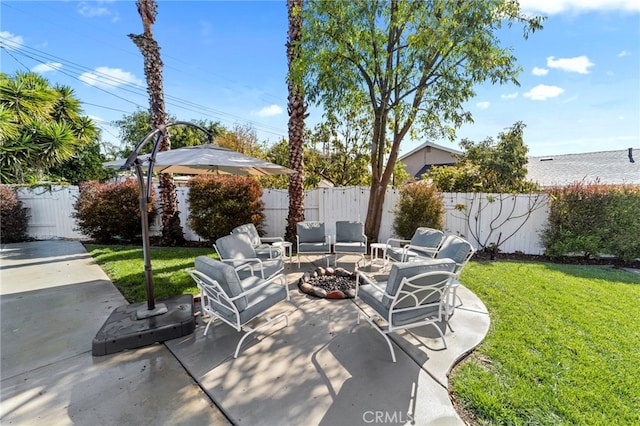 view of patio featuring an outdoor living space with a fire pit and a fenced backyard