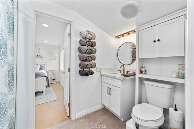 full bathroom with toilet, ensuite bath, baseboards, vanity, and vaulted ceiling