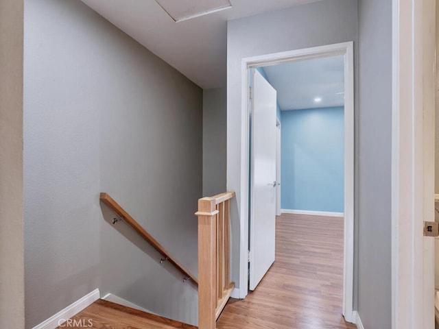 stairway featuring wood finished floors and baseboards