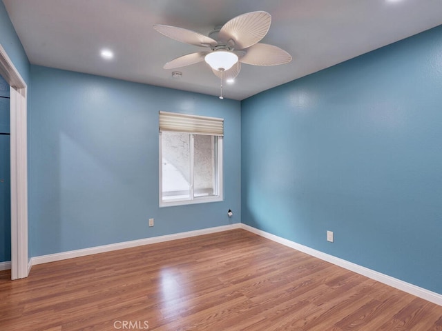 empty room featuring recessed lighting, a ceiling fan, baseboards, and wood finished floors