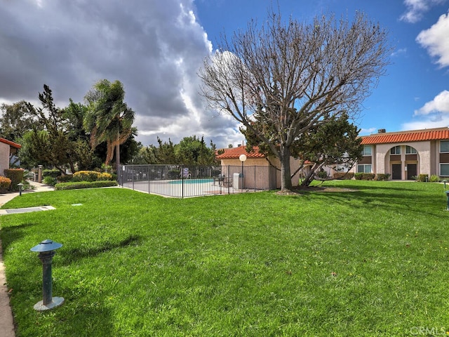 view of yard with a fenced in pool and fence