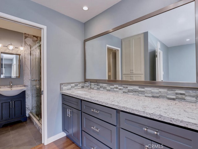 full bath with tile patterned floors, recessed lighting, a shower stall, baseboards, and vanity