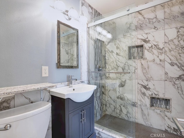 bathroom featuring vanity, toilet, and a marble finish shower