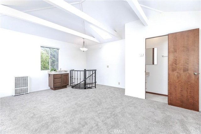 bedroom with vaulted ceiling with skylight, visible vents, and light carpet