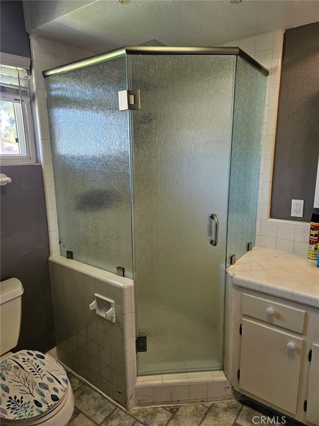 full bath featuring a stall shower and toilet