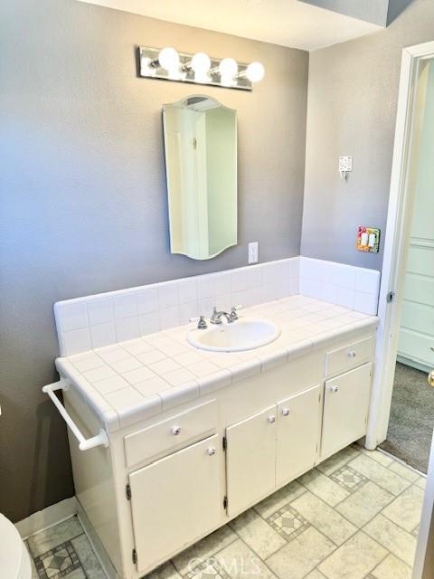 bathroom with toilet and vanity