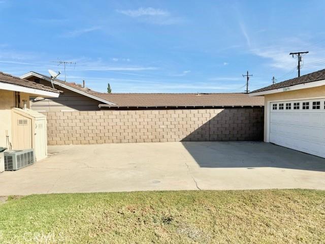 garage with cooling unit and fence