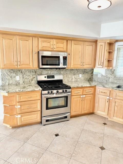 kitchen with appliances with stainless steel finishes and light brown cabinets