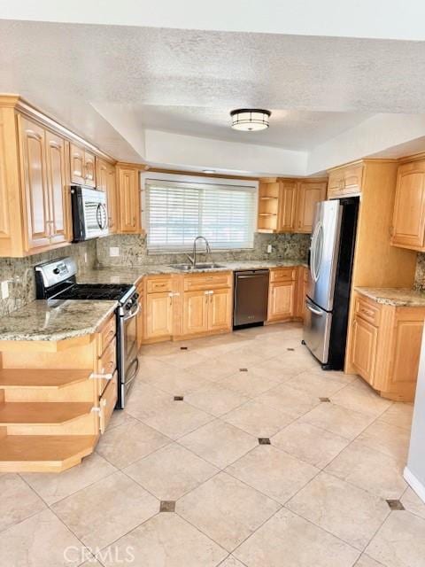 kitchen featuring light brown cabinets, a sink, open shelves, appliances with stainless steel finishes, and decorative backsplash