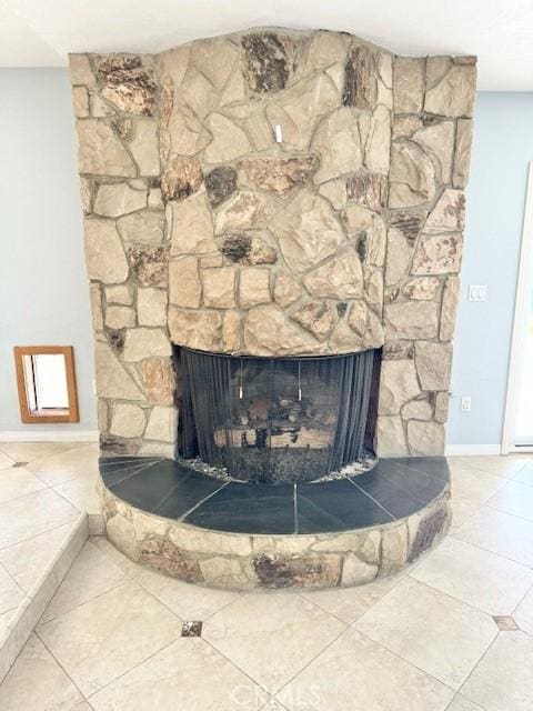 details featuring baseboards and a fireplace