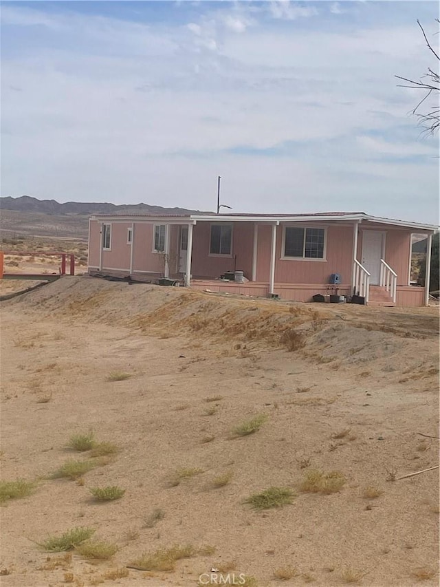 manufactured / mobile home with entry steps and a mountain view