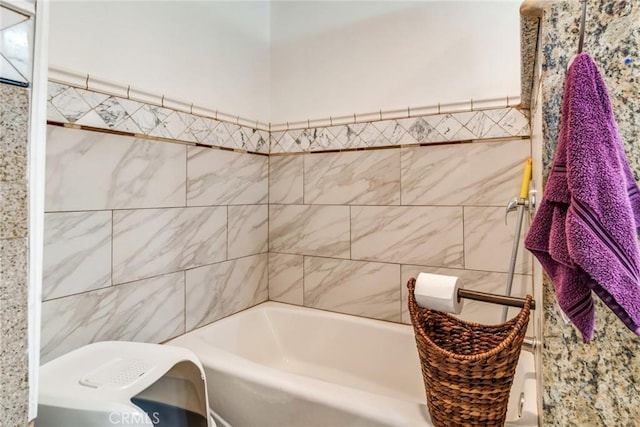 full bath featuring tile walls and a washtub