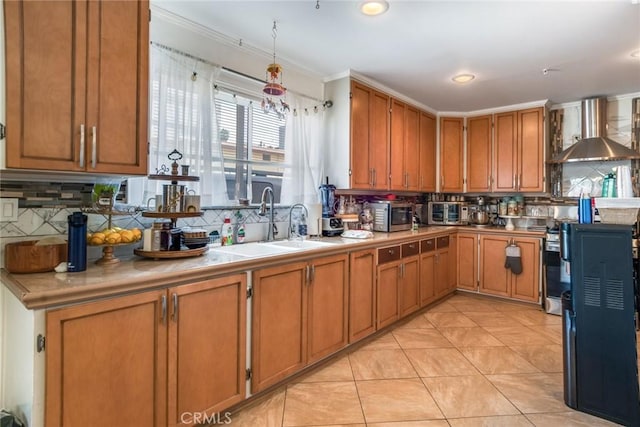 kitchen featuring decorative backsplash, brown cabinets, and wall chimney range hood